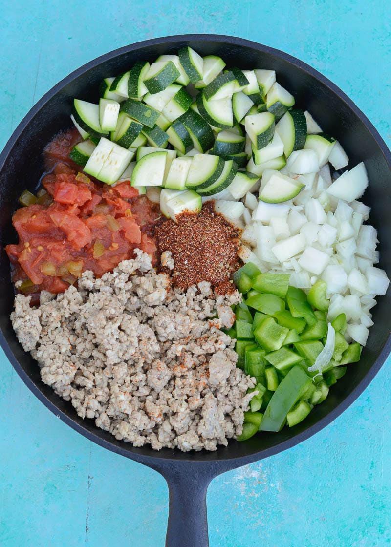 Keto Taco Casserole is the perfect healthy dinner recipe! This low carb dinner is packed with taco meat, zucchini, peppers, onions, tomatoes and cheese! 