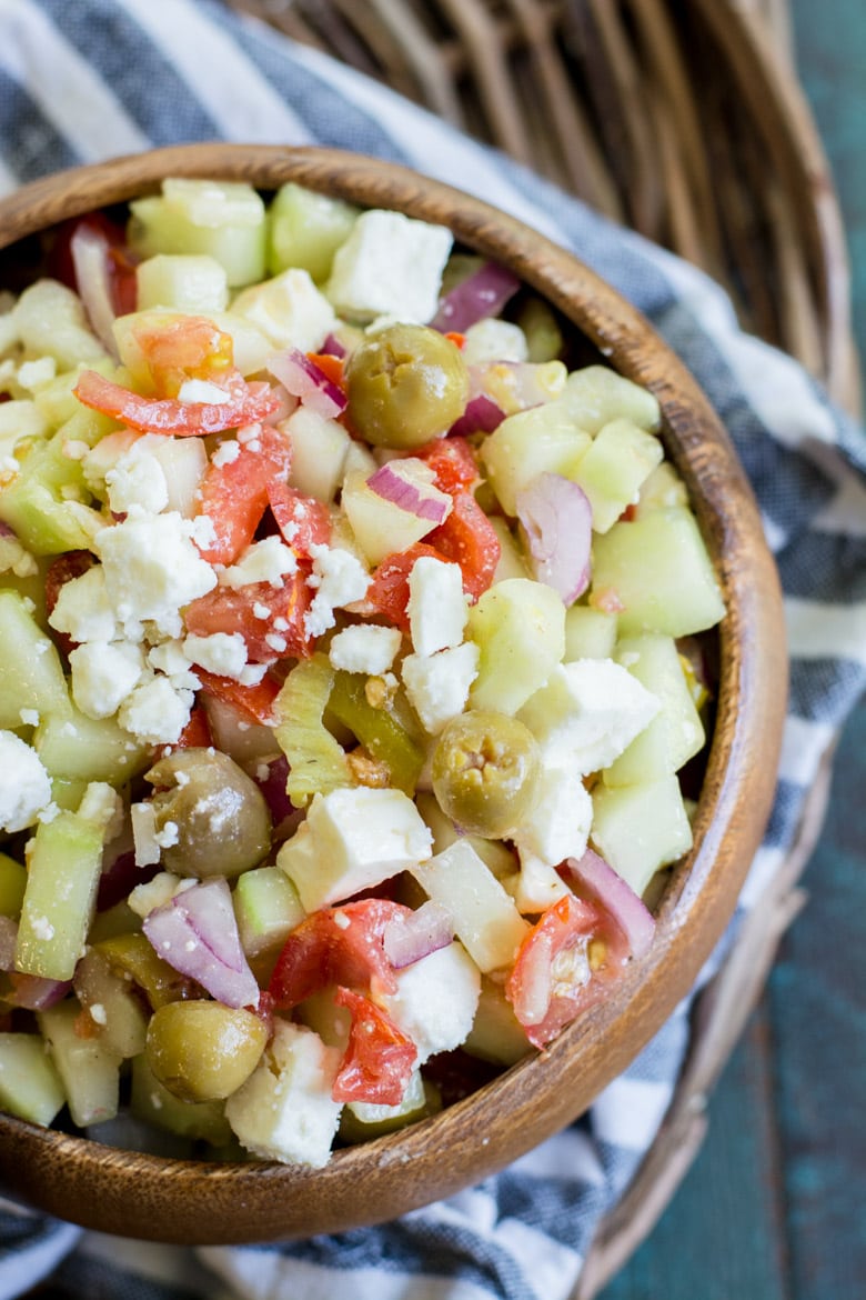 greek cucumber salad in wooden bowl