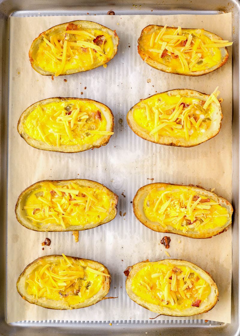 Start your day with these protein packed Breakfast Potatoes! Bacon, egg and cheddar cheese are packed in a crispy potato skin and seasoned with spicy green chilies! This easy breakfast recipe is perfect for meal prep, brunch or a family get together!
