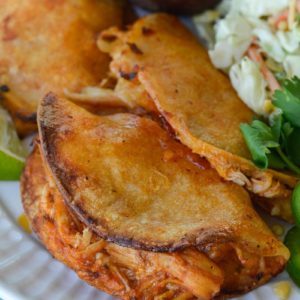 Your entire family will love these Crock Pot Chicken Tacos! Easy shredded chicken is combined with cheese, layered in a tortilla and baked to perfection!