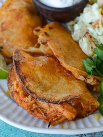 Your entire family will love these Crock Pot Chicken Tacos! Easy shredded chicken is combined with cheese, layered in a tortilla and baked to perfection!