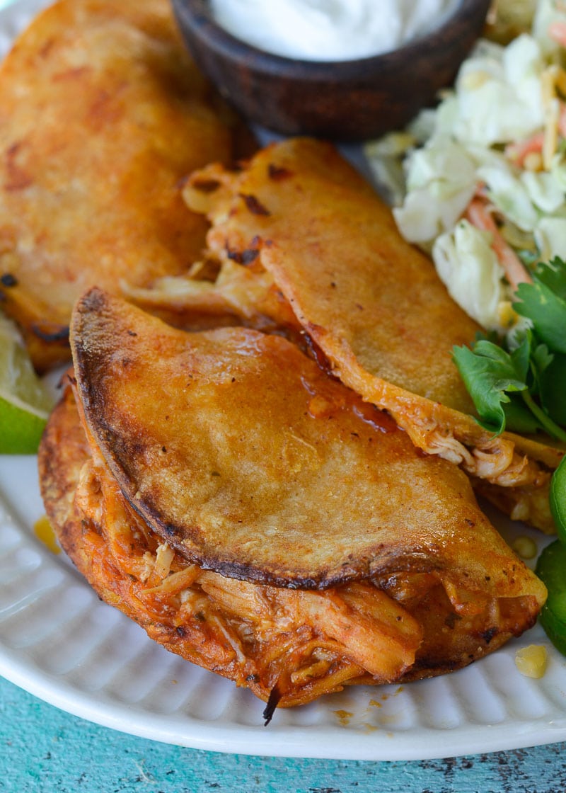 Your entire family will love these Crock Pot Chicken Tacos! Easy shredded chicken is combined with cheese, layered in a tortilla and baked to perfection!