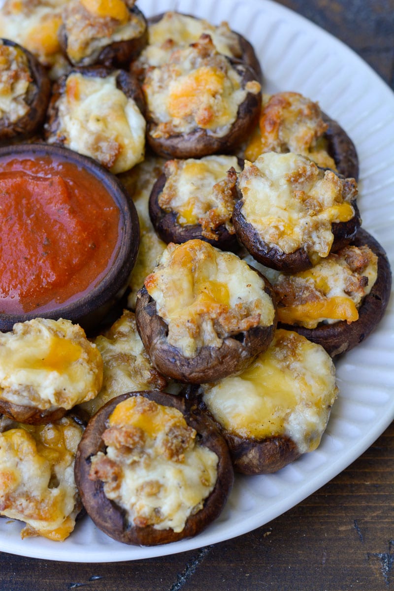 Stuffed Mushroom Appetizer This keto appetizer features healthy portobello mushrooms, which are stuffed with a mixture of savory Italian sausage, velvety cream cheese, sharp garlic and your favorite variety of cheese! There's only five ingredients in this recipe, but there is SO much flavor. This easy side dish is fantastic because it's ready in under 15 minutes, which is a huge plus when you're cooking for a crowd or on a weeknight!  Another reason I love this recipe is because it's super easy to prepare ahead of time and then either pop onto the grill or into the oven. So if you're expecting company the next day but you only have time to cook today, no problem! These stuffed mushrooms can easily be meal prepped in advance. It doesn't get much easier than that!