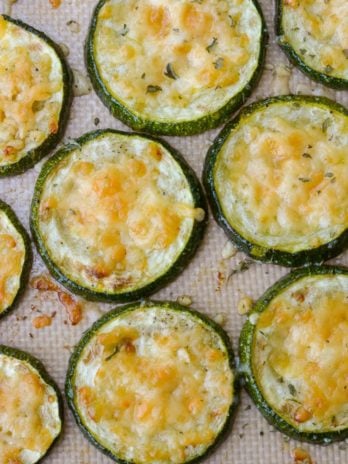 Overhead view of roasted zucchini slices topped with parmesan