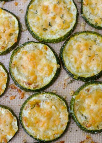 Overhead view of roasted zucchini slices topped with parmesan
