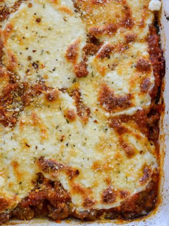 Cheesy Zucchini Casserole is the perfect five ingredient meal! This easy keto casserole is loaded with fresh zucchini, meat, marinara and cheese for about 2 net carbs per serving! 