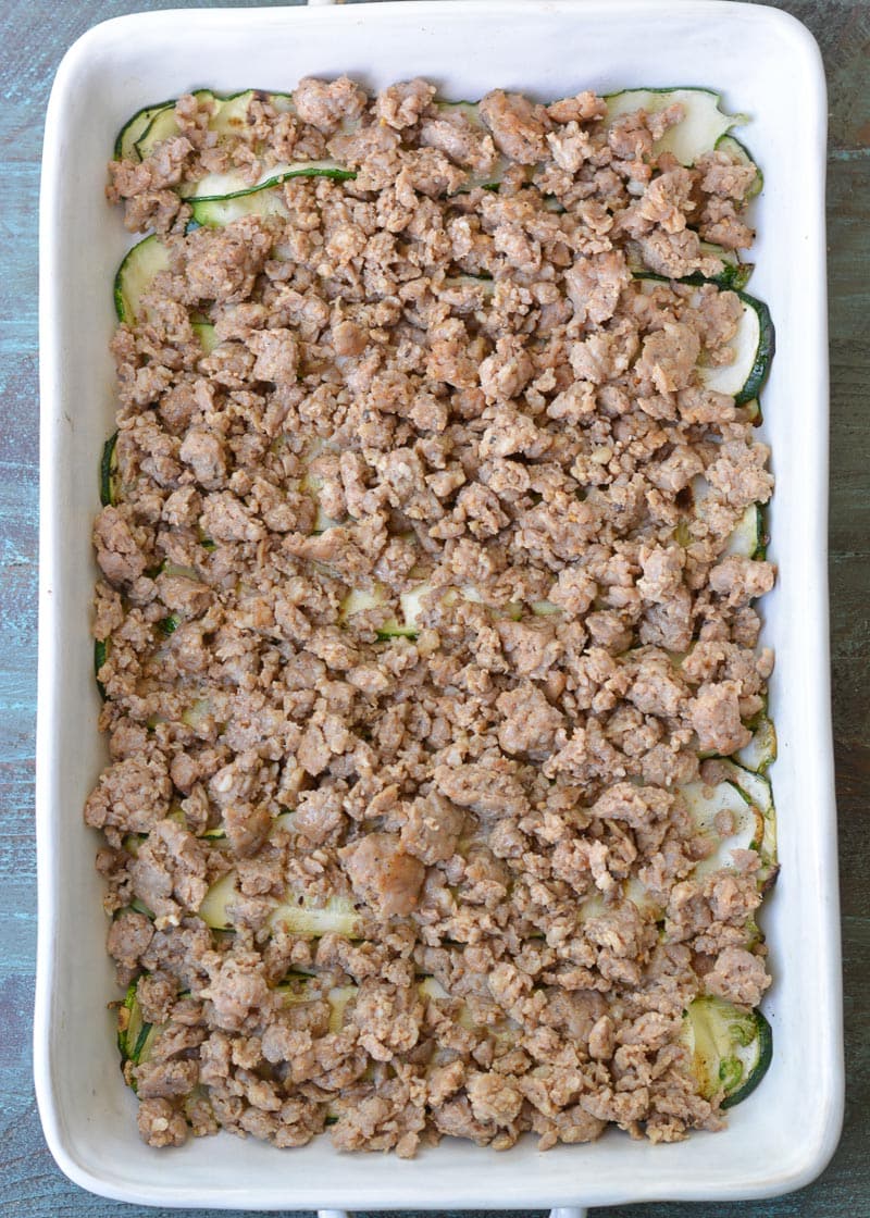 Cheesy Zucchini Casserole is the perfect five ingredient meal! This easy keto casserole is loaded with fresh zucchini, meat, marinara and cheese for about 2 net carbs per serving! 