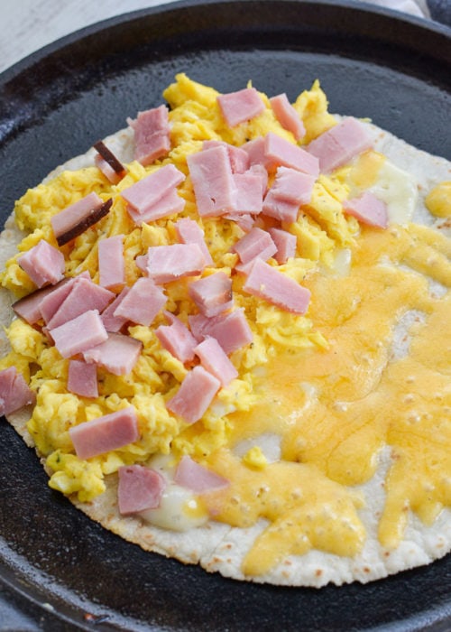 This Keto Breakfast Quesadilla is packed full with chunks of savory ham, fluffy scrambled eggs, and two types of cheese. Under 5 net carbs when made with low carb tortilla, too!