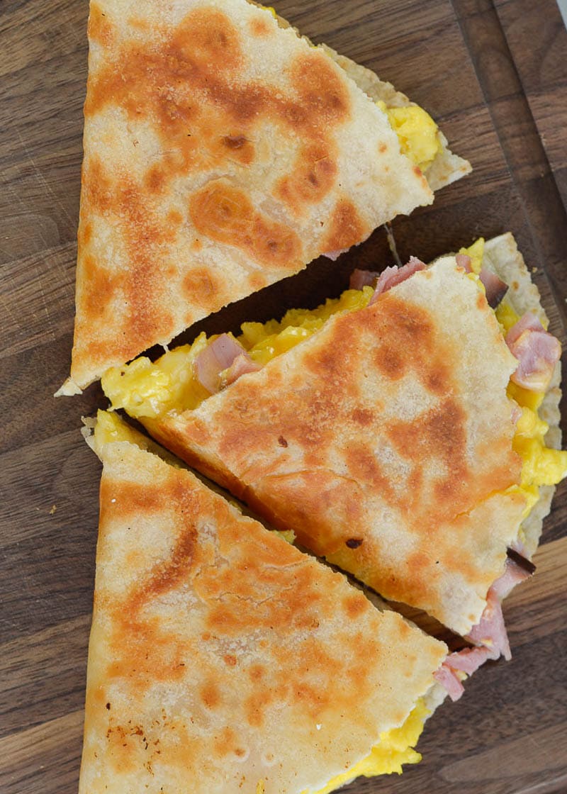 This Keto Breakfast Quesadilla is packed full with chunks of savory ham, fluffy scrambled eggs, and two types of cheese. Under 5 net carbs when made with low carb tortilla, too!