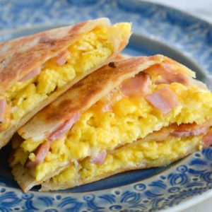 This Keto Breakfast Quesadilla is packed full with chunks of savory ham, fluffy scrambled eggs, and two types of cheese. Under 5 net carbs when made with low carb tortilla, too!