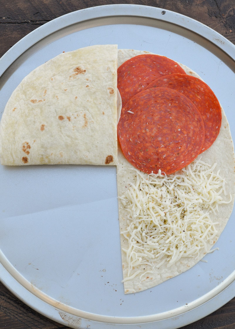 This Crispy Pizza Tortilla is an easy recipe you will love! It can be made low carb and gluten free for a delicious snack packed full of of meat and cheese!