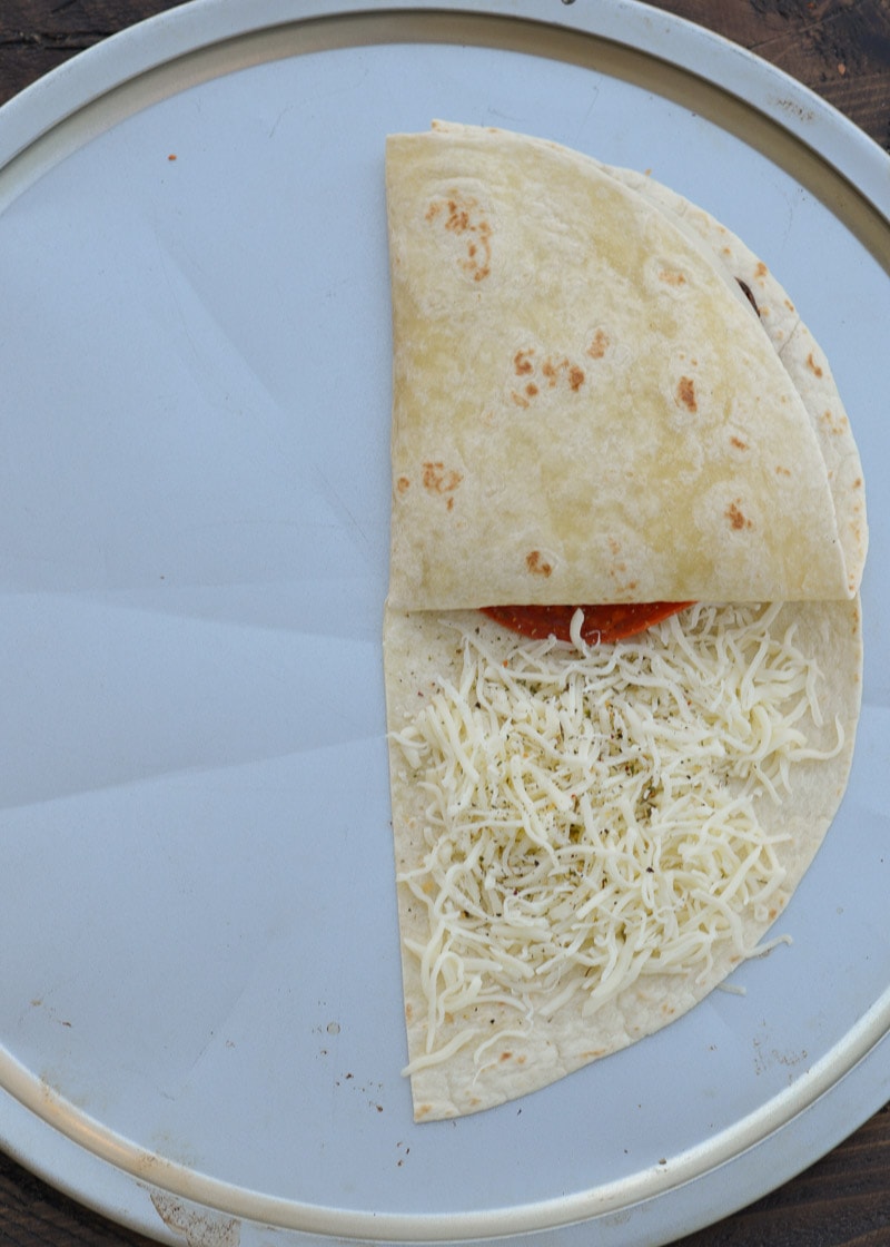This Crispy Pizza Tortilla is an easy recipe you will love! It can be made low carb and gluten free for a delicious snack packed full of of meat and cheese!