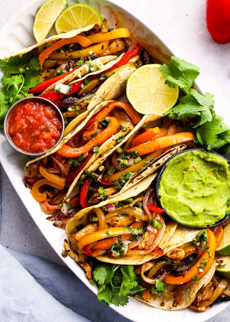 These Chicken Fajitas are packed with flavor for an easy, healthy meal! The chicken is flavored with a homemade marinade, then grilled to perfection.