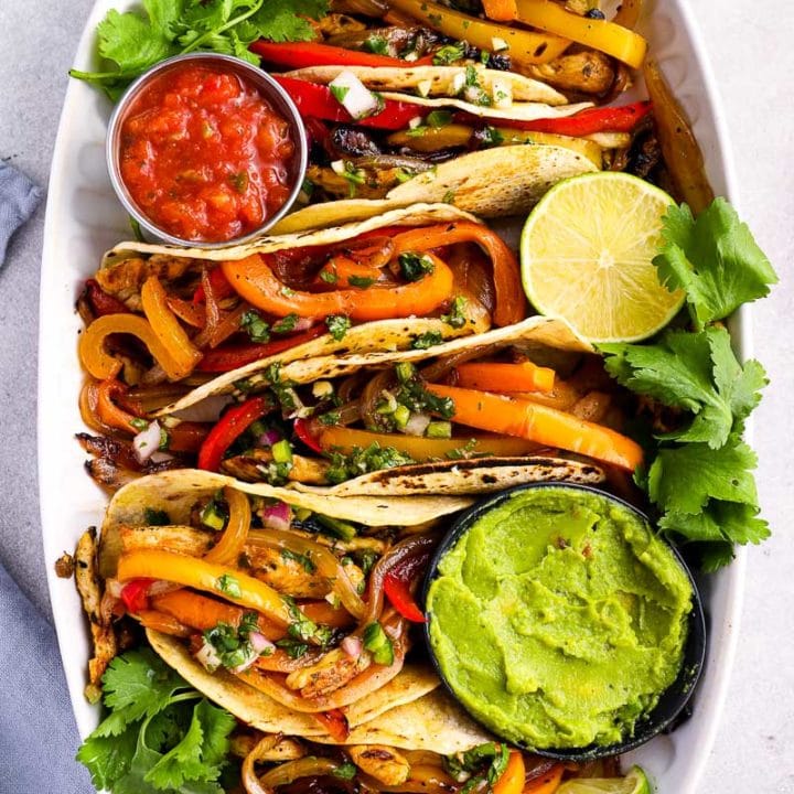 These Chicken Fajitas are packed with flavor for an easy, healthy meal! The chicken is flavored with a homemade marinade, then grilled to perfection.