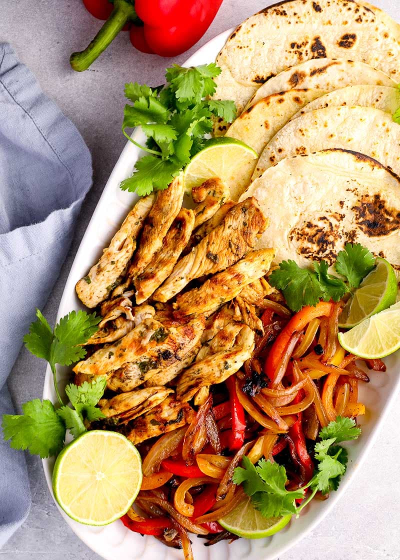 These Chicken Fajitas are packed with flavor for an easy, healthy meal! The chicken is flavored with a homemade marinade, then grilled to perfection.