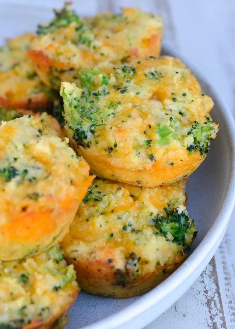 broccoli cheddar muffins on a white speckled plate