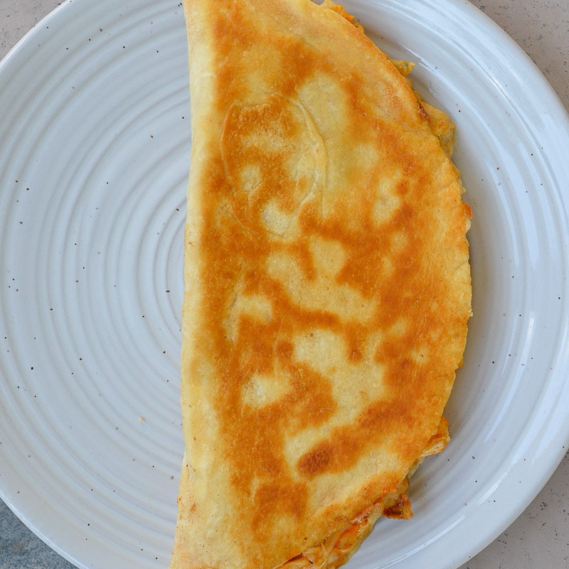 This Cheesy Buffalo Chicken Quesadilla is the ultimate weeknight dinner! Shredded chicken is combined with blue cheese, mozzarella and buffalo sauce and is cooked to perfection!