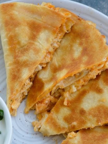 This Cheesy Buffalo Chicken Quesadilla is the ultimate weeknight dinner! Shredded chicken is combined with blue cheese, mozzarella and buffalo sauce and is cooked to perfection!