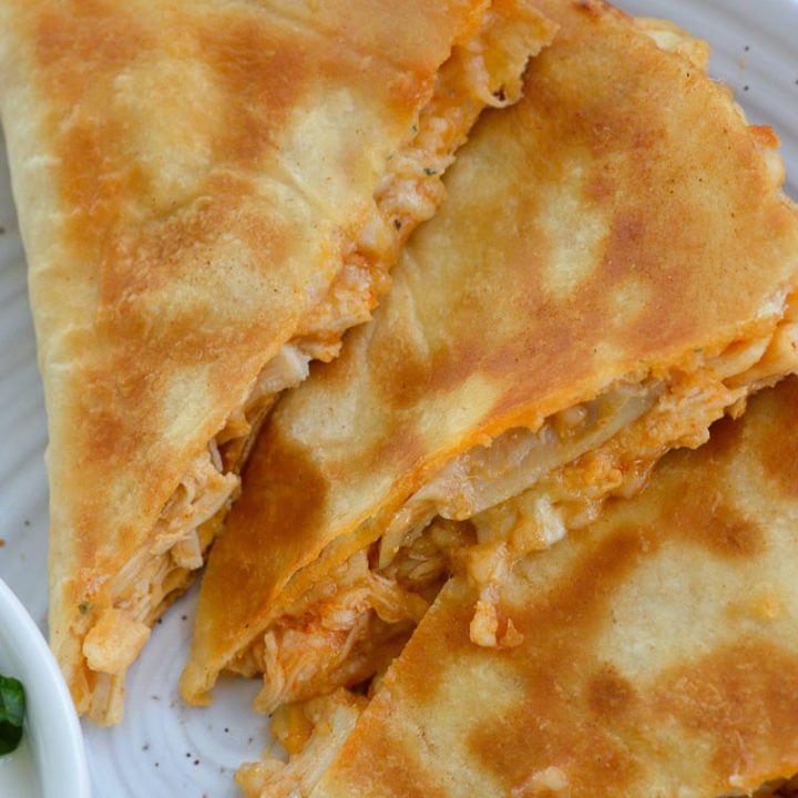 This Cheesy Buffalo Chicken Quesadilla is the ultimate weeknight dinner! Shredded chicken is combined with blue cheese, mozzarella and buffalo sauce and is cooked to perfection!