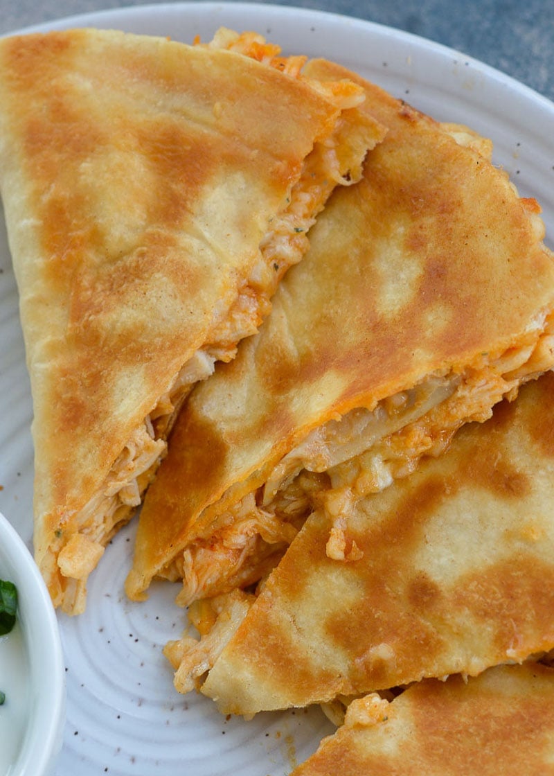 This Cheesy Buffalo Chicken Quesadilla is the ultimate weeknight dinner! Shredded chicken is combined with blue cheese, mozzarella and buffalo sauce and is cooked to perfection!