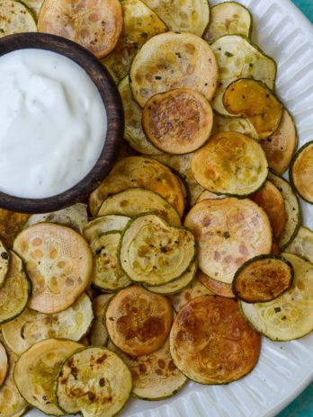 Crispy Zucchini Chips are the perfect healthy snack! Thinly sliced zucchini is roasted until it gives a satisfying crunch- you'll love this easy keto recipe!