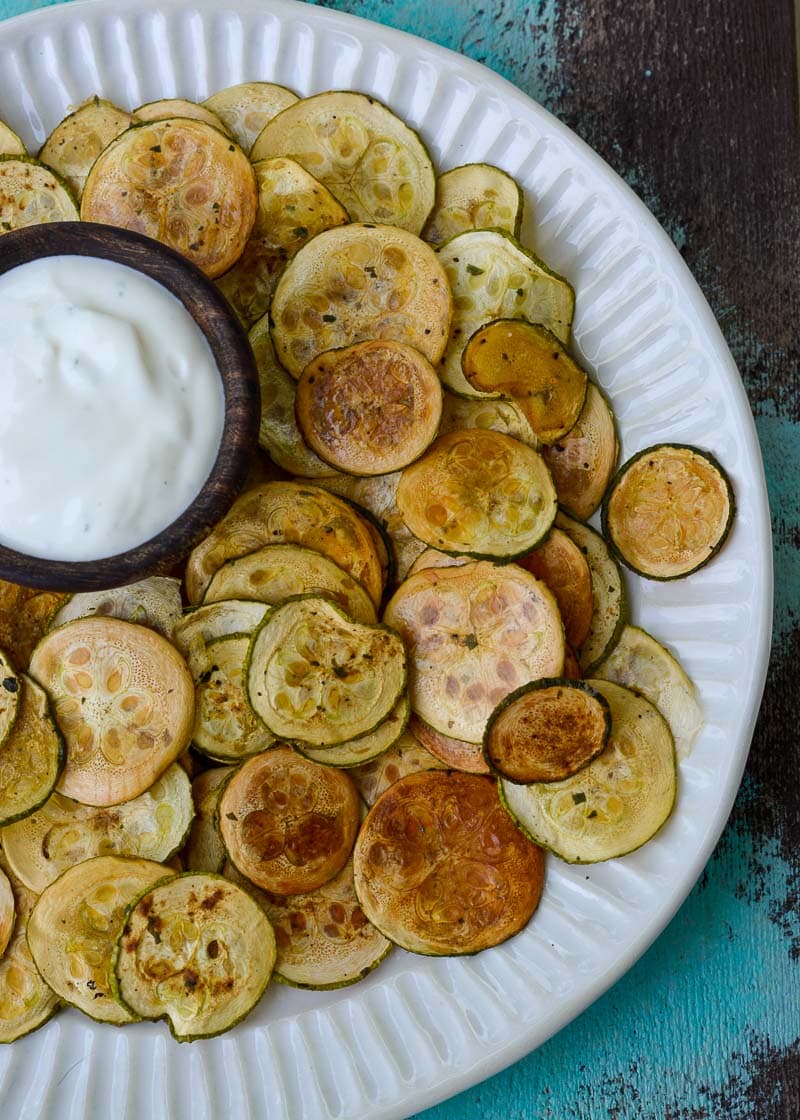 Crispy Zucchini Chips are the perfect healthy snack! Thinly sliced zucchini is roasted until it gives a satisfying crunch- you'll love this easy keto recipe!