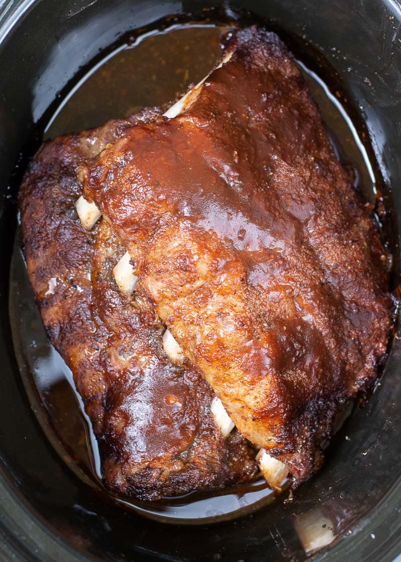 Try these ultra tender Crock Pot Ribs for the perfect easy meal! First ribs are seasoned with a smokey BBQ rub, cooked until super tender and then smothered in BBQ sauce and broiled to perfection! 