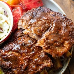 Try these ultra tender Crock Pot Ribs for the perfect easy meal! First ribs are seasoned with a smokey BBQ rub, cooked until super tender and then smothered in BBQ sauce and broiled to perfection! 