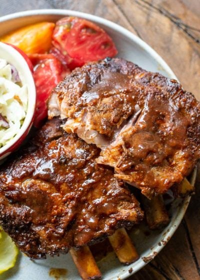 Try these ultra tender Crock Pot Ribs for the perfect easy meal! First ribs are seasoned with a smokey BBQ rub, cooked until super tender and then smothered in BBQ sauce and broiled to perfection! 