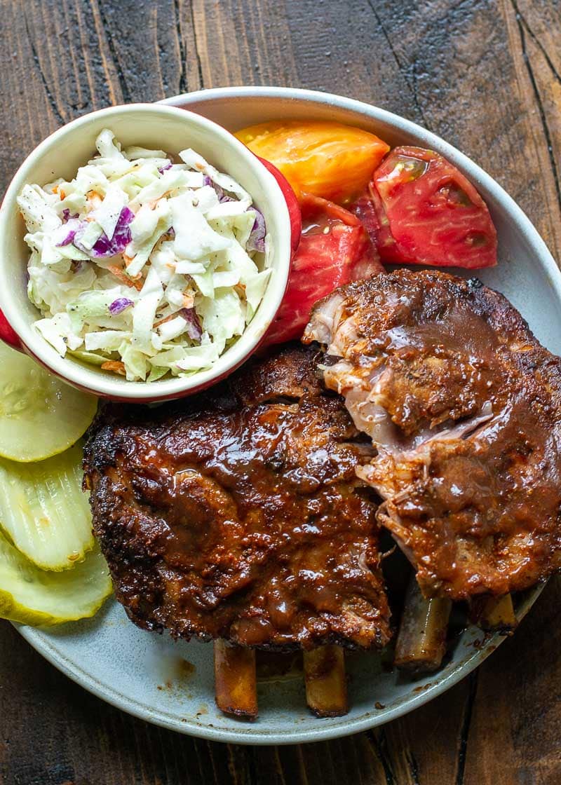 Try these ultra tender Crock Pot Ribs for the perfect easy meal! First ribs are seasoned with a smokey BBQ rub, cooked until super tender and then smothered in BBQ sauce and broiled to perfection! 