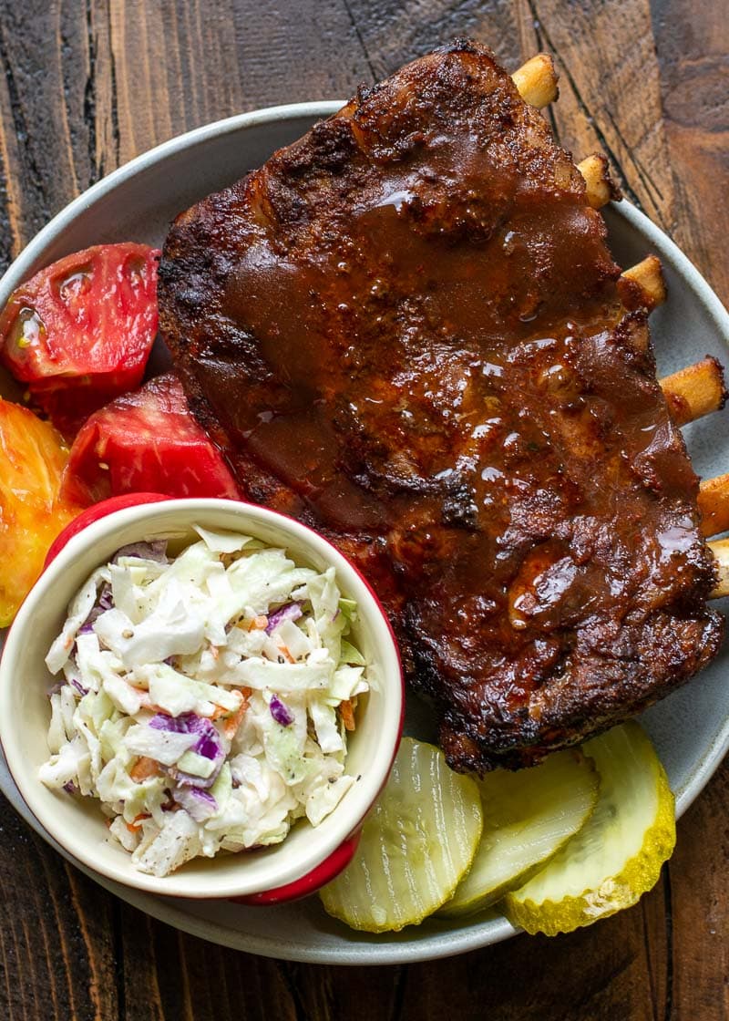 Try these ultra tender Crock Pot Ribs for the perfect easy meal! First ribs are seasoned with a smokey BBQ rub, cooked until super tender and then smothered in BBQ sauce and broiled to perfection! 