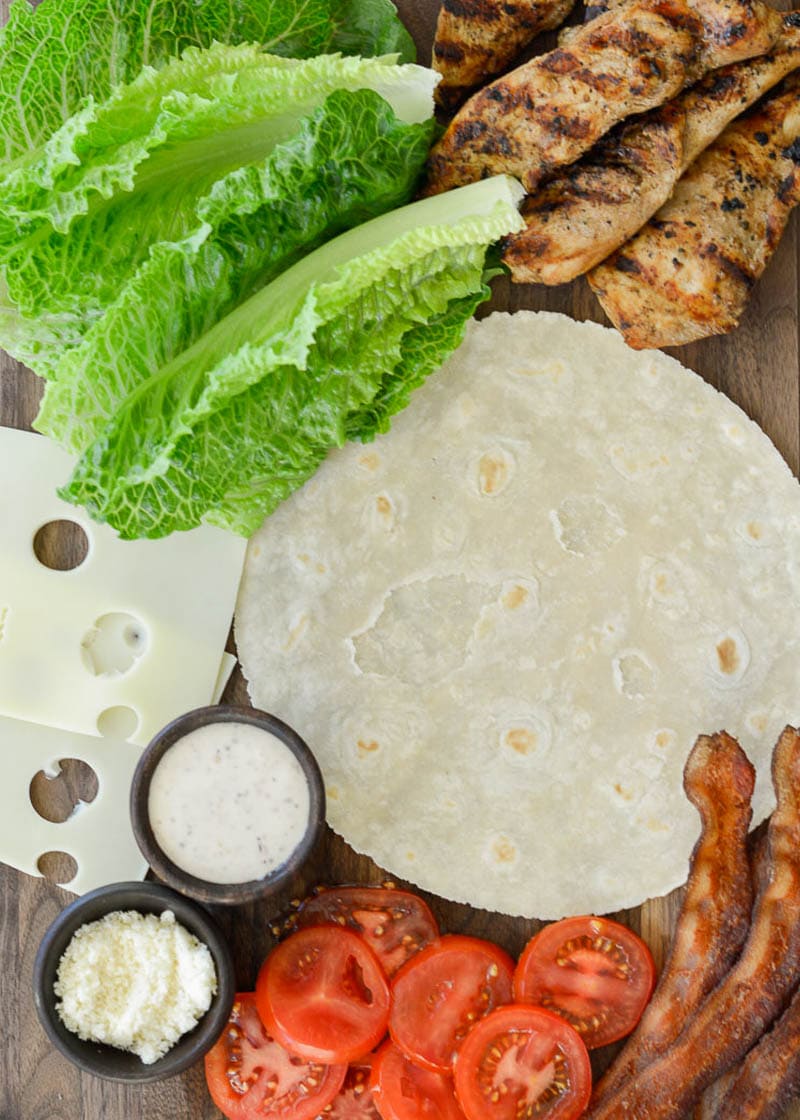 This Chicken Caesar Wrap is packed with juicy chicken, tangy Caesar dressing, tomatoes, lettuce, and two types of cheese. This healthy lunch recipe can be meal prepped and made low-carb, or gluten free, too!