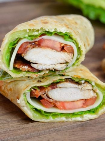 This Chicken Caesar Wrap is packed with juicy chicken, tangy Caesar dressing, tomatoes, lettuce, and two types of cheese. This healthy lunch recipe can be meal prepped and made low-carb, or gluten free, too!