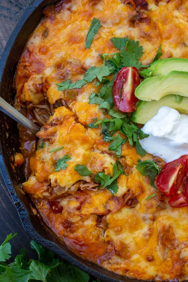 This one pan Chicken Enchilada Skillet is loaded with shredded chicken, tomatoes, green chilies and a creamy sauce! Enjoy a generous serving of this easy keto chicken recipe for under 5 net carbs!