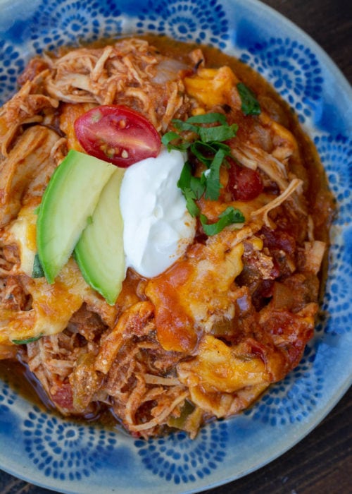 This one pan Chicken Enchilada Skillet is loaded with shredded chicken, tomatoes, green chilies and a creamy sauce! Enjoy a generous serving of this easy keto chicken recipe for under 5 net carbs!
