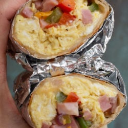 This Denver Omelette Breakfast Burrito is a delicious low carb breakfast! Fluffy eggs are combined with peppers, onions, ham and cheese, making a perfect meal prep recipe!