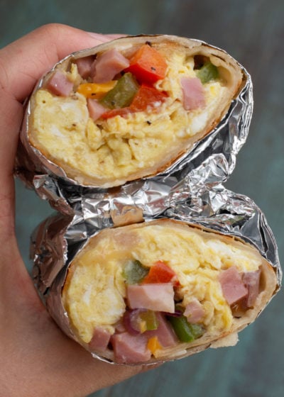 This Denver Omelette Breakfast Burrito is a delicious low carb breakfast! Fluffy eggs are combined with peppers, onions, ham and cheese, making a perfect meal prep recipe!