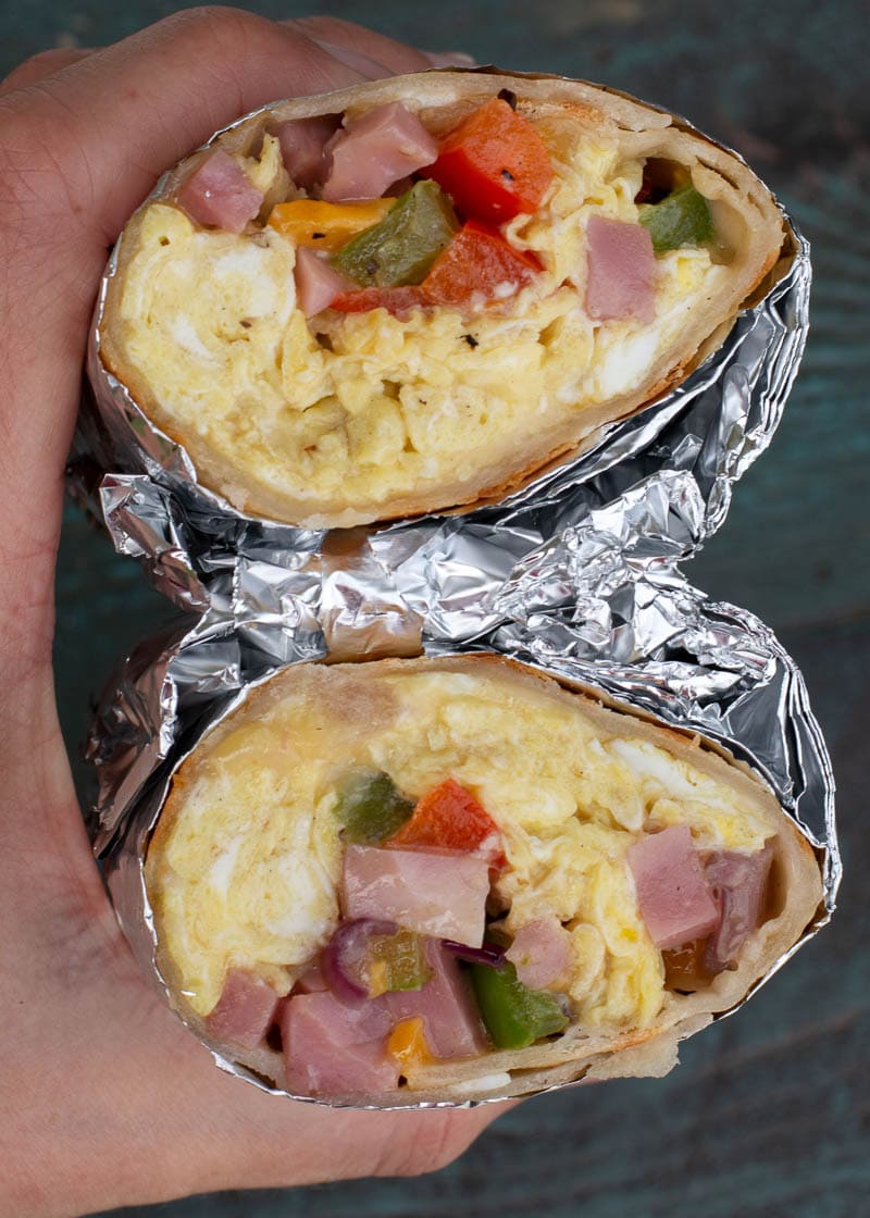 This Denver Omelette Breakfast Burrito is a delicious low carb breakfast! Fluffy eggs are combined with peppers, onions, ham and cheese, making a perfect meal prep recipe!