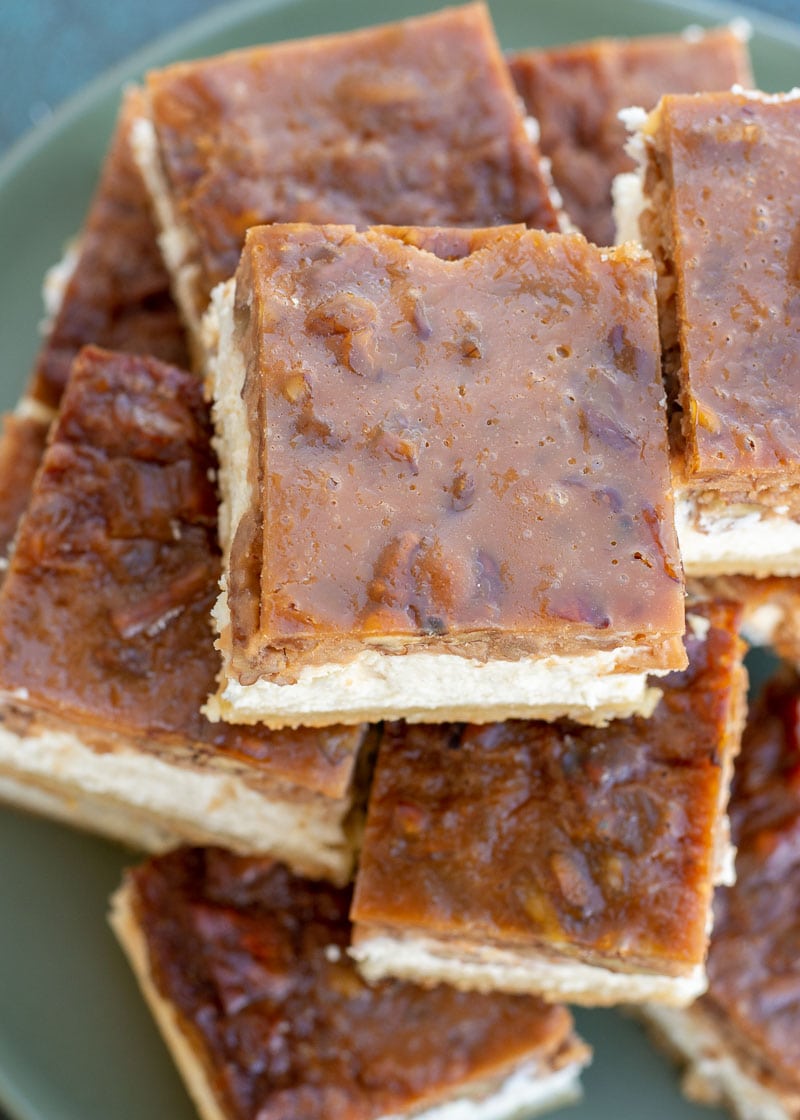 These Pecan Pie Cheesecake Bars feature a shortbread cookie crust, vanilla cheesecake and delicious pecan pie layer! This impressive dessert is keto-friendly and has just 5 net carbs per slice!