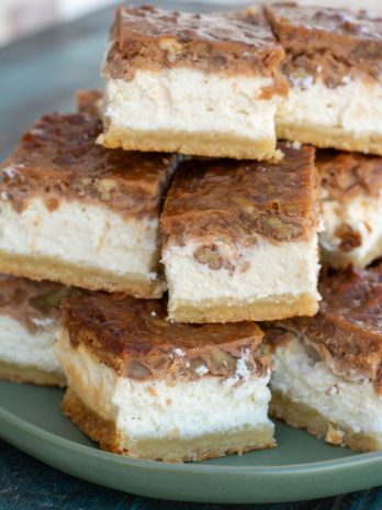 These Pecan Pie Cheesecake Bars feature a shortbread cookie crust, vanilla cheesecake and delicious pecan pie layer! This impressive dessert is keto-friendly and has just 5 net carbs per slice!