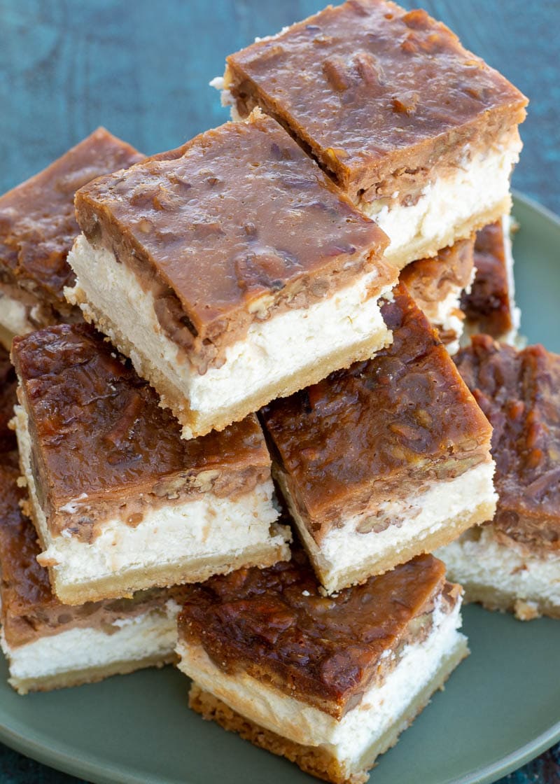 These Pecan Pie Cheesecake Bars feature a shortbread cookie crust, vanilla cheesecake and delicious pecan pie layer! This impressive dessert is keto-friendly and has just 5 net carbs per slice!