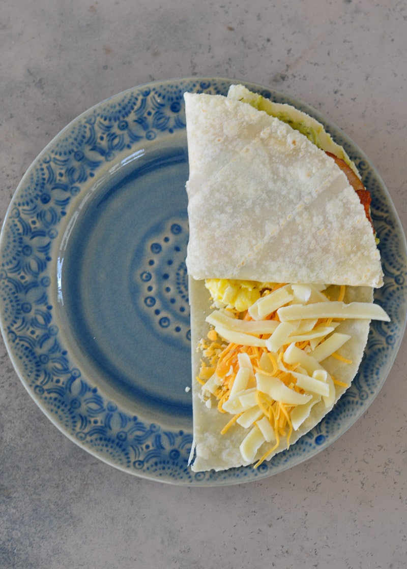This Bacon Egg and Cheese Tortilla is the ultimate keto breakfast! Fluffy eggs, salty bacon, cheddar cheese and creamy avocado are all packed into a tortilla for a delicious, filling breakfast on the go!