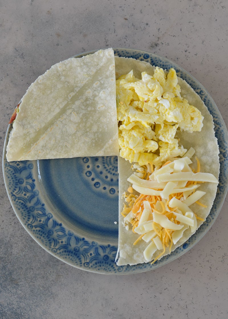 This Bacon Egg and Cheese Tortilla is the ultimate keto breakfast! Fluffy eggs, salty bacon, cheddar cheese and creamy avocado are all packed into a tortilla for a delicious, filling breakfast on the go!