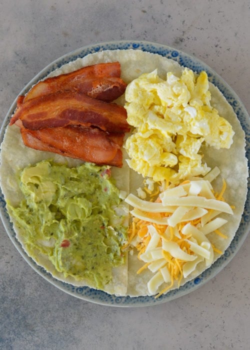 This Bacon Egg and Cheese Tortilla is the ultimate keto breakfast! Fluffy eggs, salty bacon, cheddar cheese and creamy avocado are all packed into a tortilla for a delicious, filling breakfast on the go!