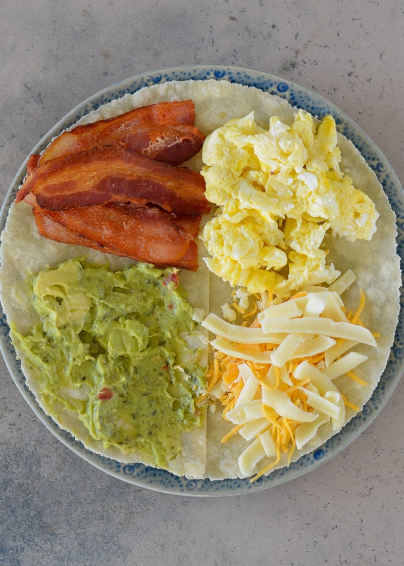 This Bacon Egg and Cheese Tortilla is the ultimate keto breakfast! Fluffy eggs, salty bacon, cheddar cheese and creamy avocado are all packed into a tortilla for a delicious, filling breakfast on the go!