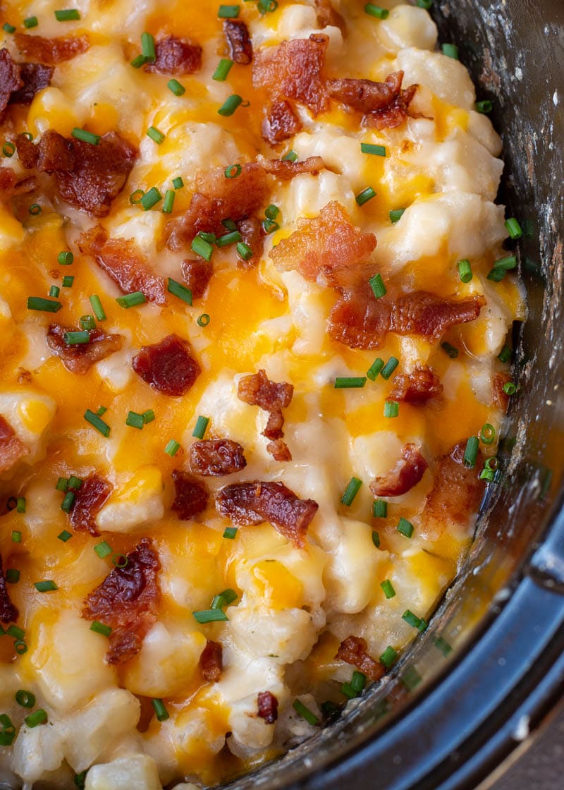 These Crockpot Cheesy Potatoes require a few basic ingredients and no prep! Simply dump the ingredients for these cheesy potatoes in a slow cooker, mix and forget it! This is the best side dish recipe!