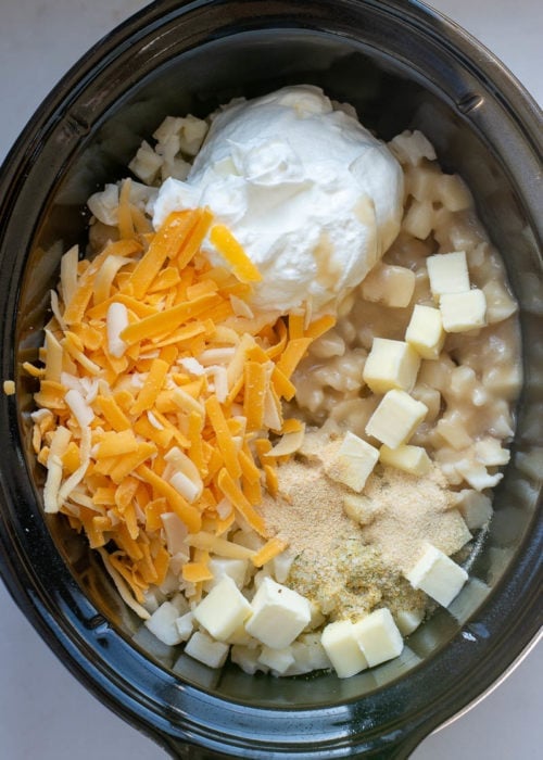 These Crockpot Cheesy Potatoes require a few basic ingredients and no prep! Simply dump the ingredients for these cheesy potatoes in a slow cooker, mix and forget it! This is the best side dish recipe!