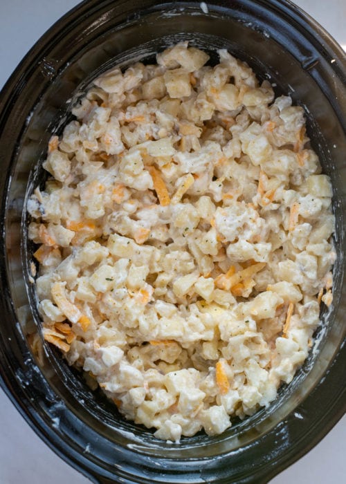 These Crockpot Cheesy Potatoes require a few basic ingredients and no prep! Simply dump the ingredients for these cheesy potatoes in a slow cooker, mix and forget it! This is the best side dish recipe!