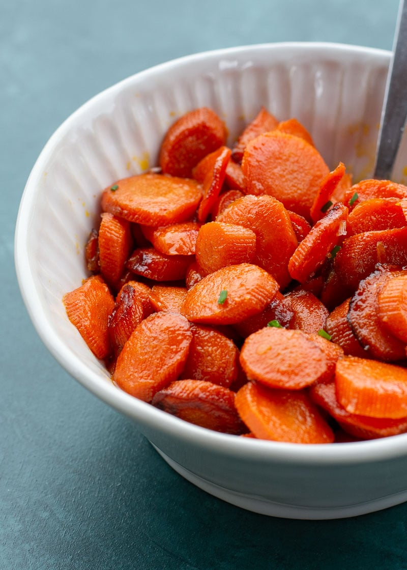 These easy Glazed Carrots require just 4 ingredients and are ready in about 15 minutes! This is the perfect holiday side dish that can be made ahead of time. 