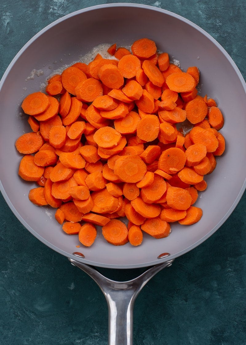 These easy Glazed Carrots require just 4 ingredients and are ready in about 15 minutes! This is the perfect holiday side dish that can be made ahead of time. 